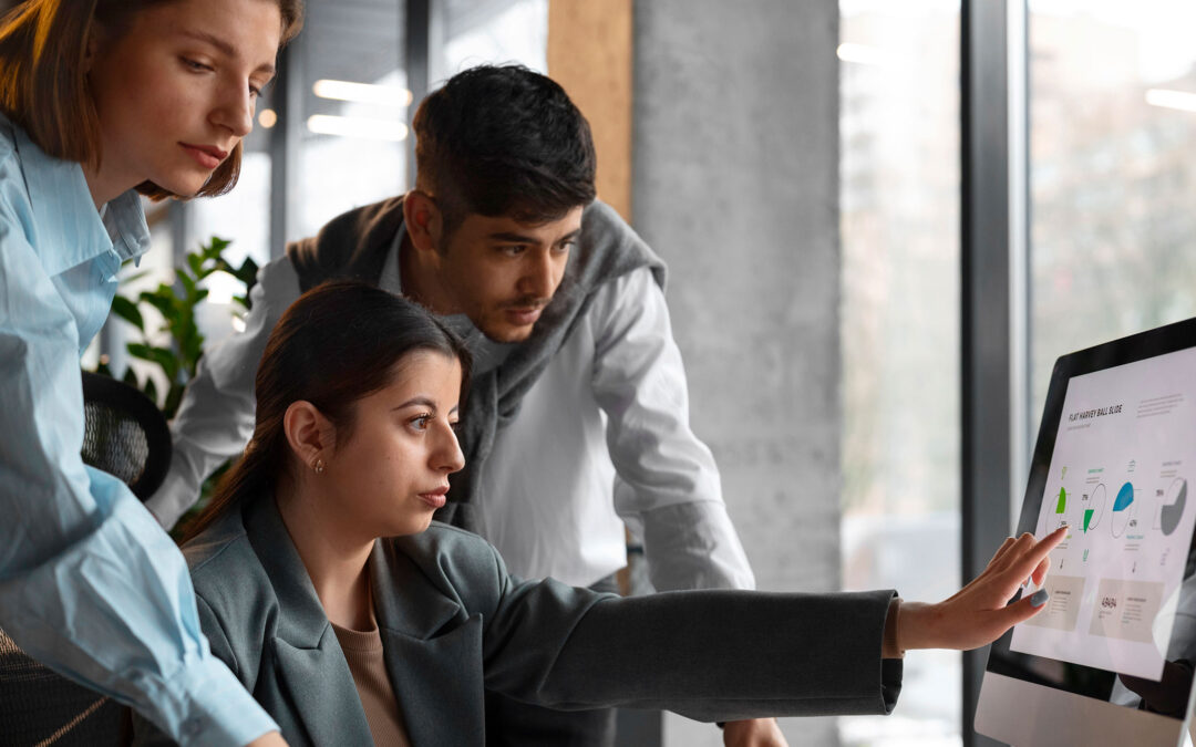 Image of office employees using a computer with their knowledge